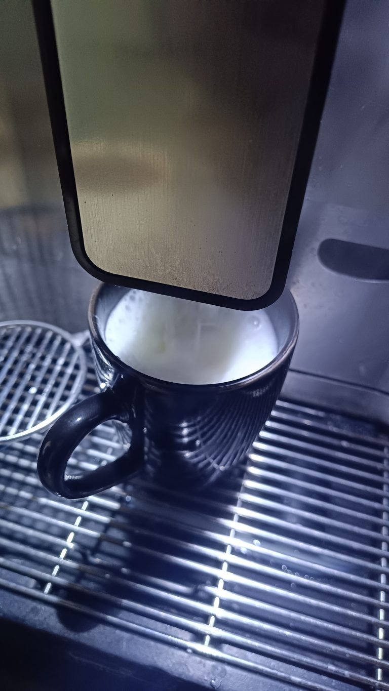 Milk in a cup from a coffee machine