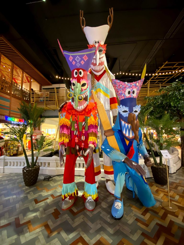 A group of colorfully decorated wooden figures on display