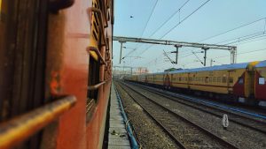 The view from a train to the railway station, tracks and the power-lines. 