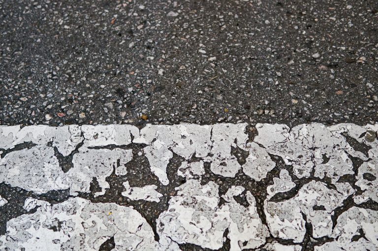 Closeup detail of a cracked pedestrian crossing