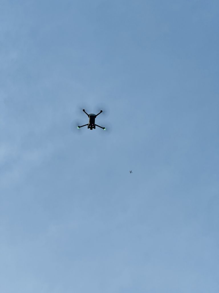 Two drones flying to take aerial shots.