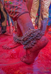  Colorful legs adorned with anklets, dancing in the vibrant hues of Holi celebration.
