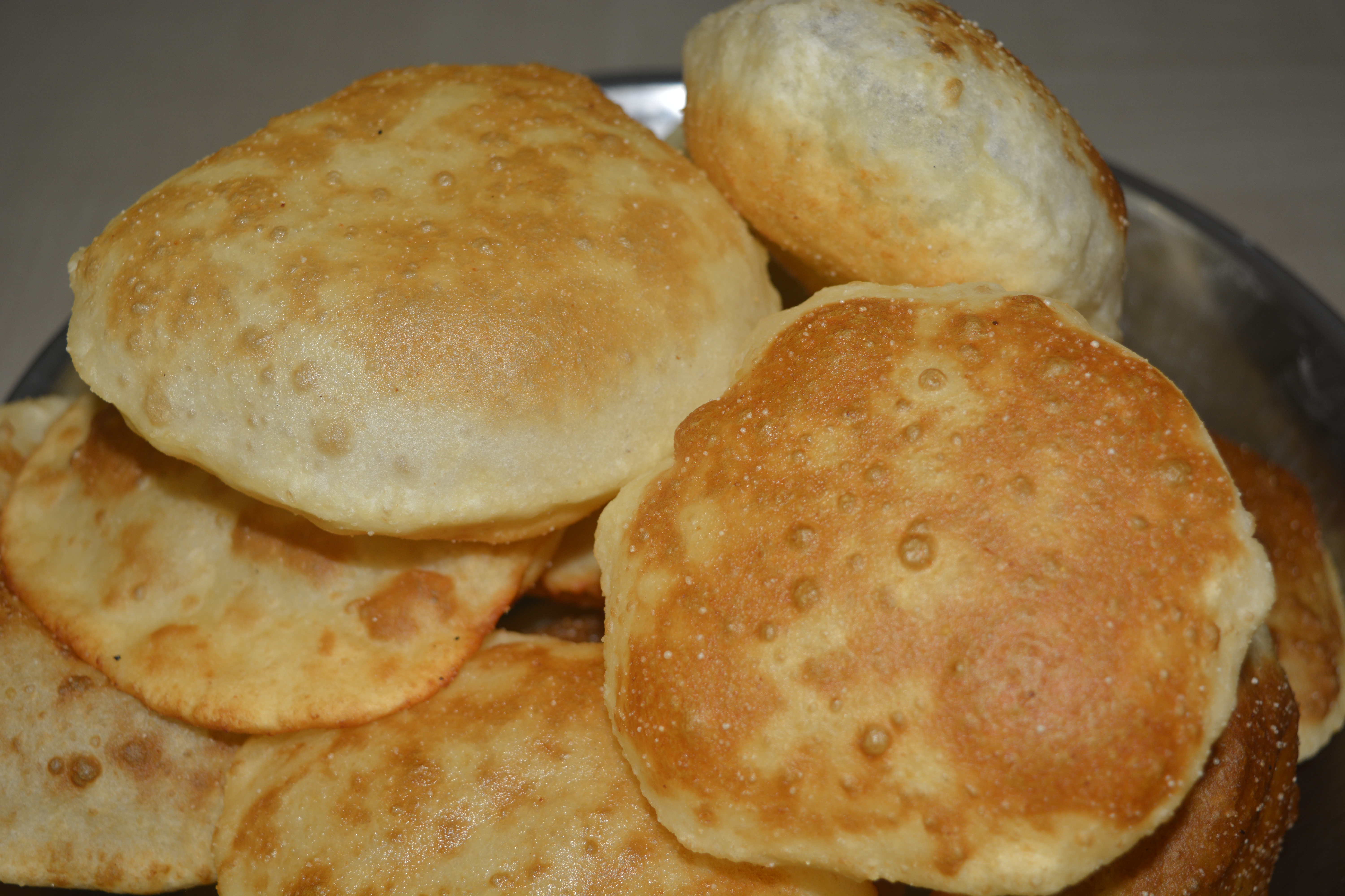 Poori, an Indian bread made of flour deep fried in oil.