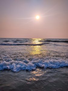 Calicut beach with waves at sunset