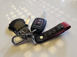 Keychain with keys laying on a white table
