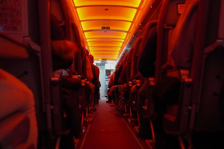 Airplane interior, red night light on.