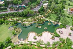  An aerial view of a park with a pond
