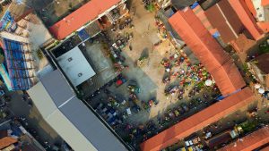 Aerial view of the market, with buildings vehicles and people waking around, kozhikode, Kerala.