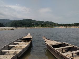 Scenic river view: Tranquil waters with a boat, nature's serenity captured in a peaceful moment.