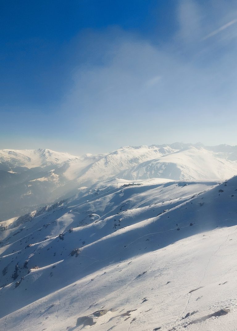 The snow-capped peaks and clear blue skies make for the perfect winter adventure.