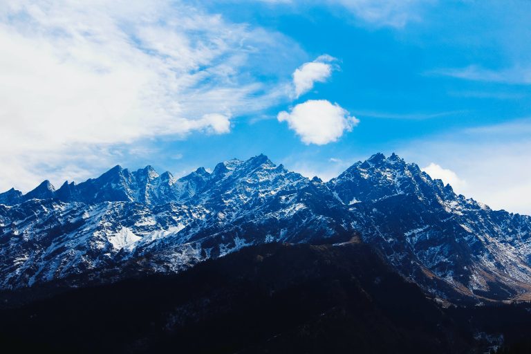 Ice-covered mountain peak rising majestically against a blue sky