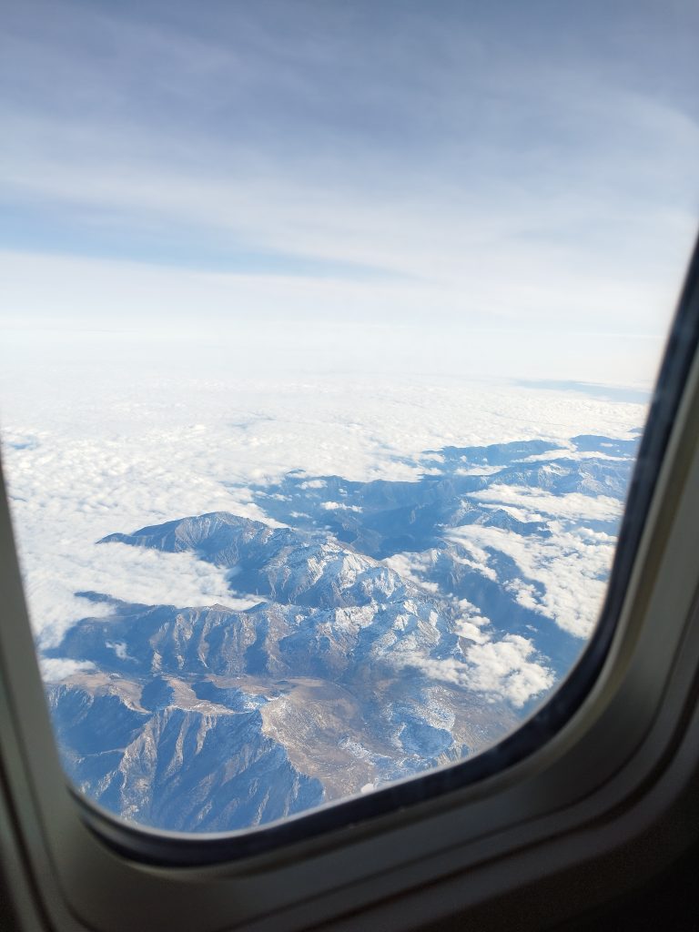 Mountains and clouds through an airplane window