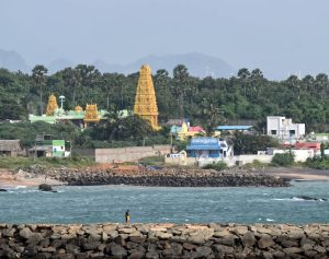 Ocean view from breakwater with village in background located in Kanyakumari.