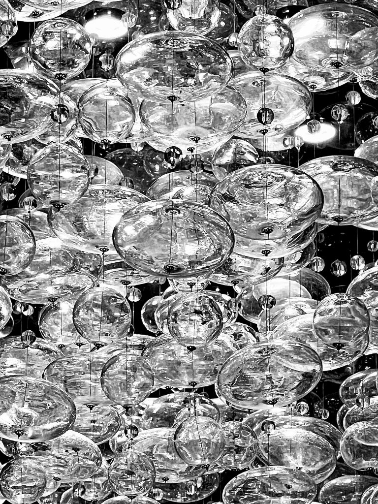 Glass bubbles hanging from a ceiling as part of a chandelier