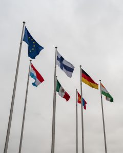 Various flags and a cloudy sky
