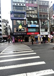 Taiwan cross walk with people and buildings