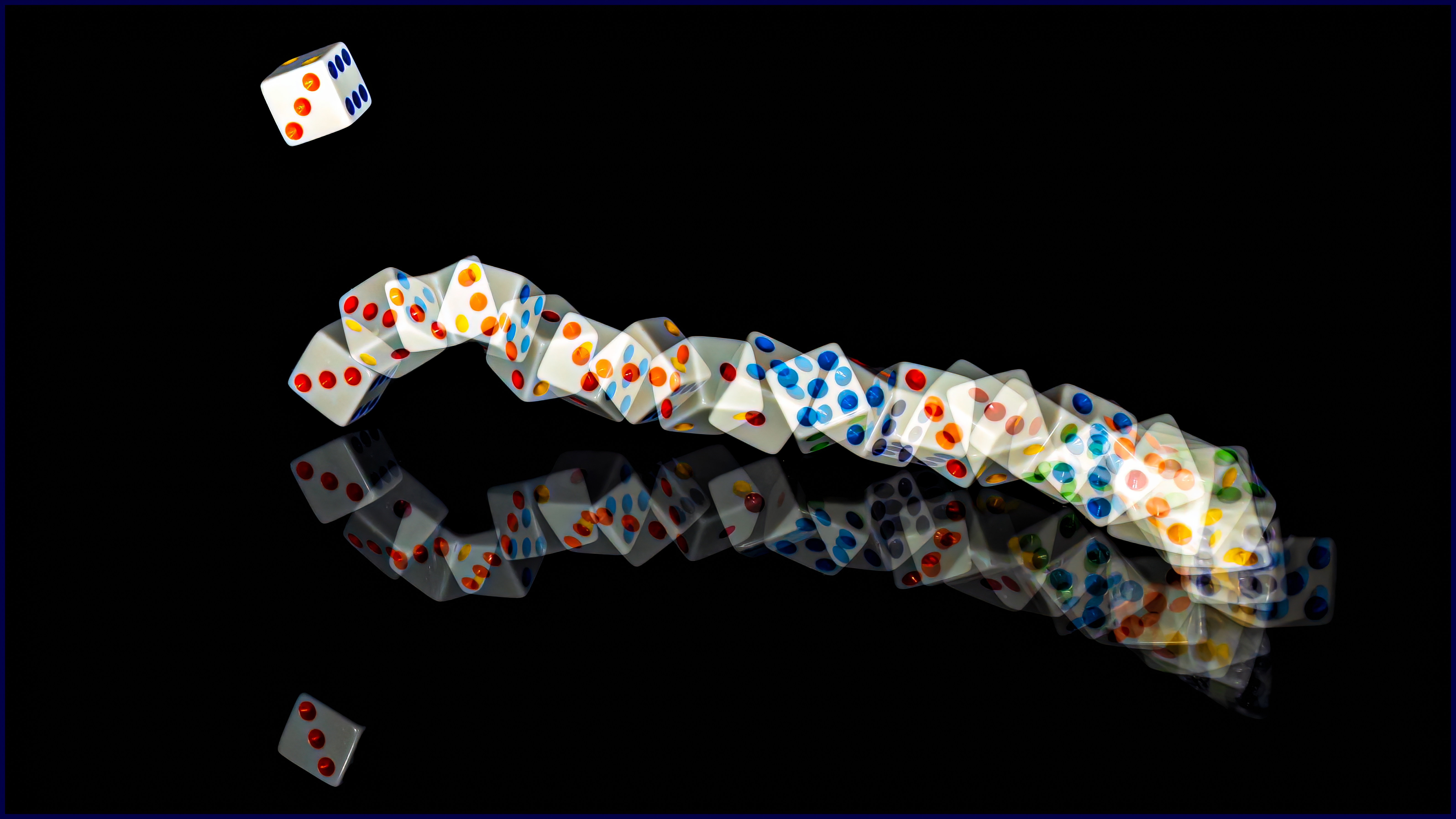 A trail of colorful dice reflecting on a glossy black surface, with two dice seemingly suspended in mid-air above the trail.