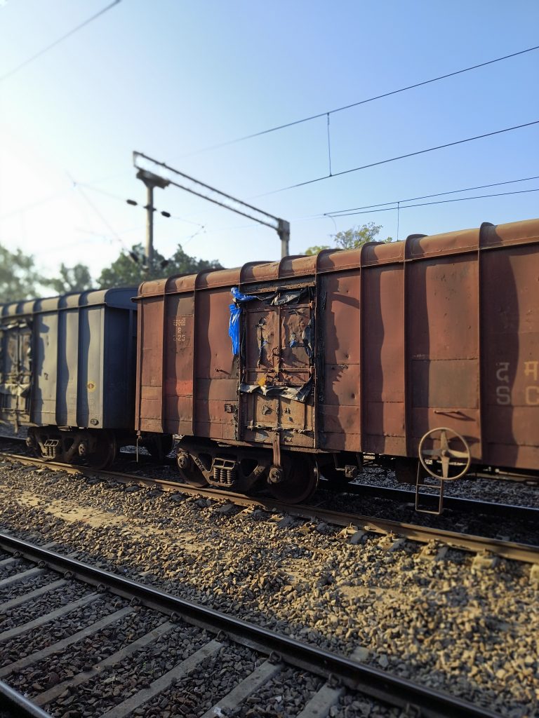 Train car parked on tracks, stationary with no passengers inside.