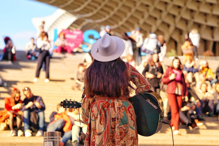 Street performer singing in front of a crowd