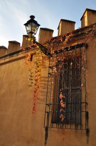 Wall, window and street lamp in the late afternoon in Seville, Spain