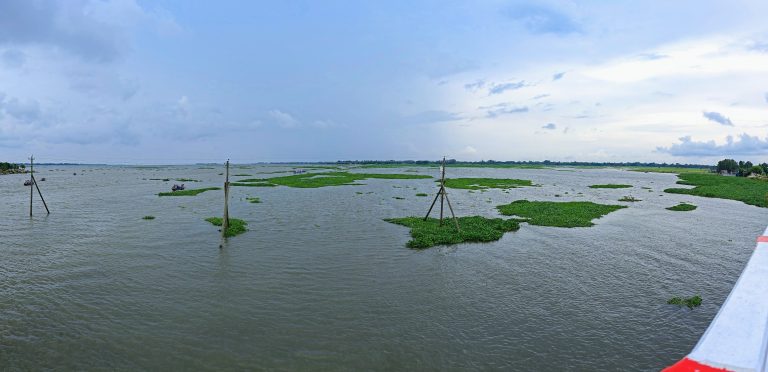 Cloudy sky above a river, as seen from a bridge, creates a tranquil and scenic view