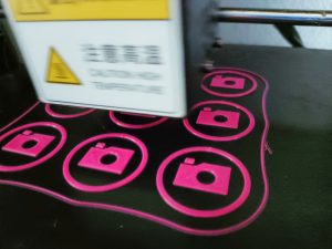 3D printer printing bright pink WordPress Photo team badges