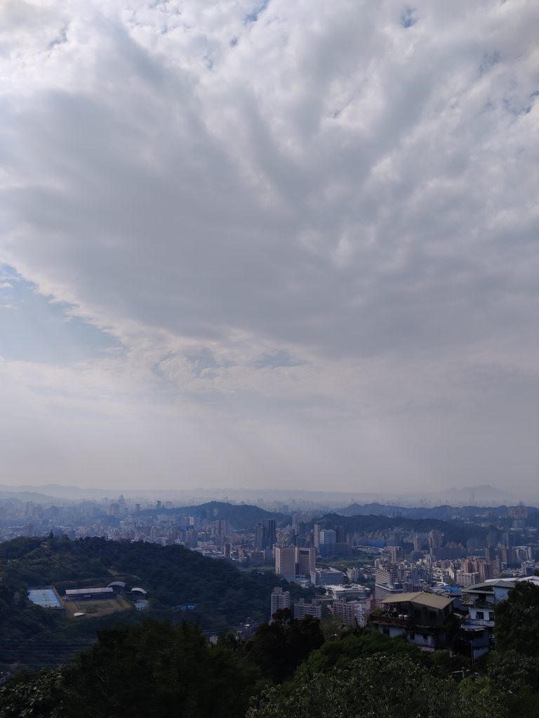 Overview of Taipei city in Taiwan from the top of the mountain. You can see the whole city panoram, nature and sky.