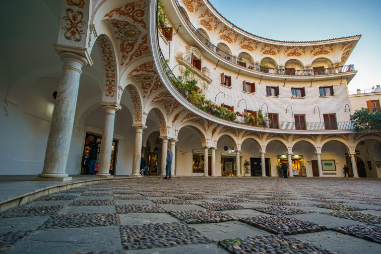 Plaza del Cabildo in Sevilla, Spain. Round square surrounded by columns and arches