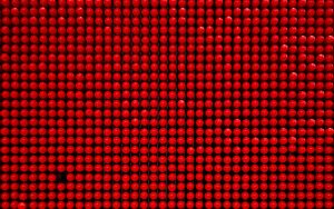 Pegboard made of red shiny balls