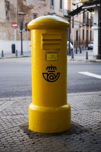 Bright yellow mailbox in the street
