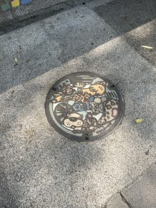 Cute animal-themed manhole cover outside the Taipei Zoo