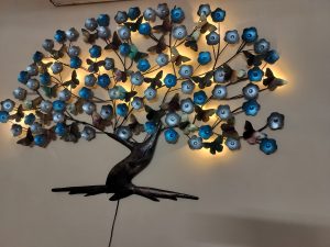 Beautiful art on the wall in metal depicting a tree with butterflies