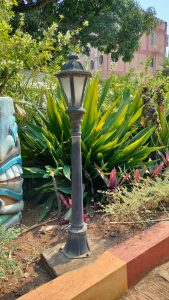 Small old-fashioned iron street night lamp in a garden