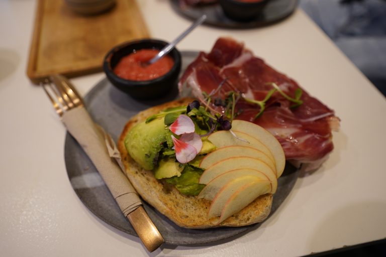 Avocado toast with ham and random things on top