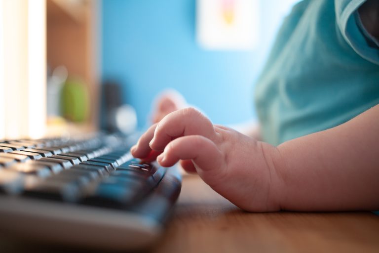 Childs hands typing on a keyboard