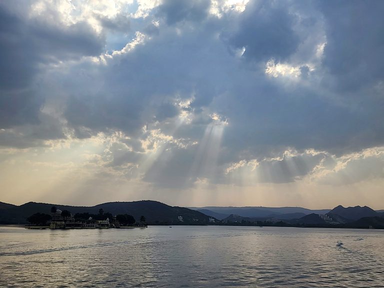 Sunlight through the clouds over the lake.