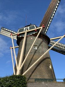 Closeup of a windmill with a blue sky in the background
