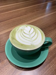 Hot matcha green tea latte in a cup
