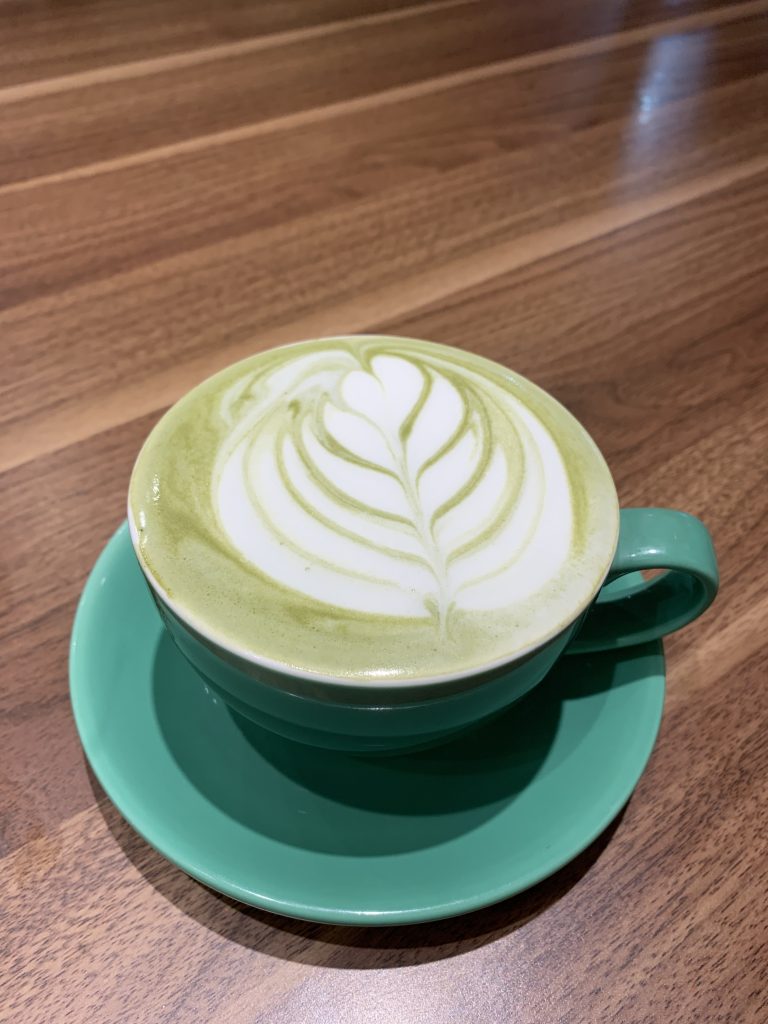 Hot matcha green tea latte in a cup