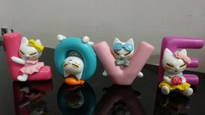 Figures with cats spelling “LOVE”

