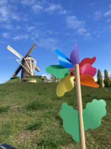 a windmill and a child's colored pinwheel