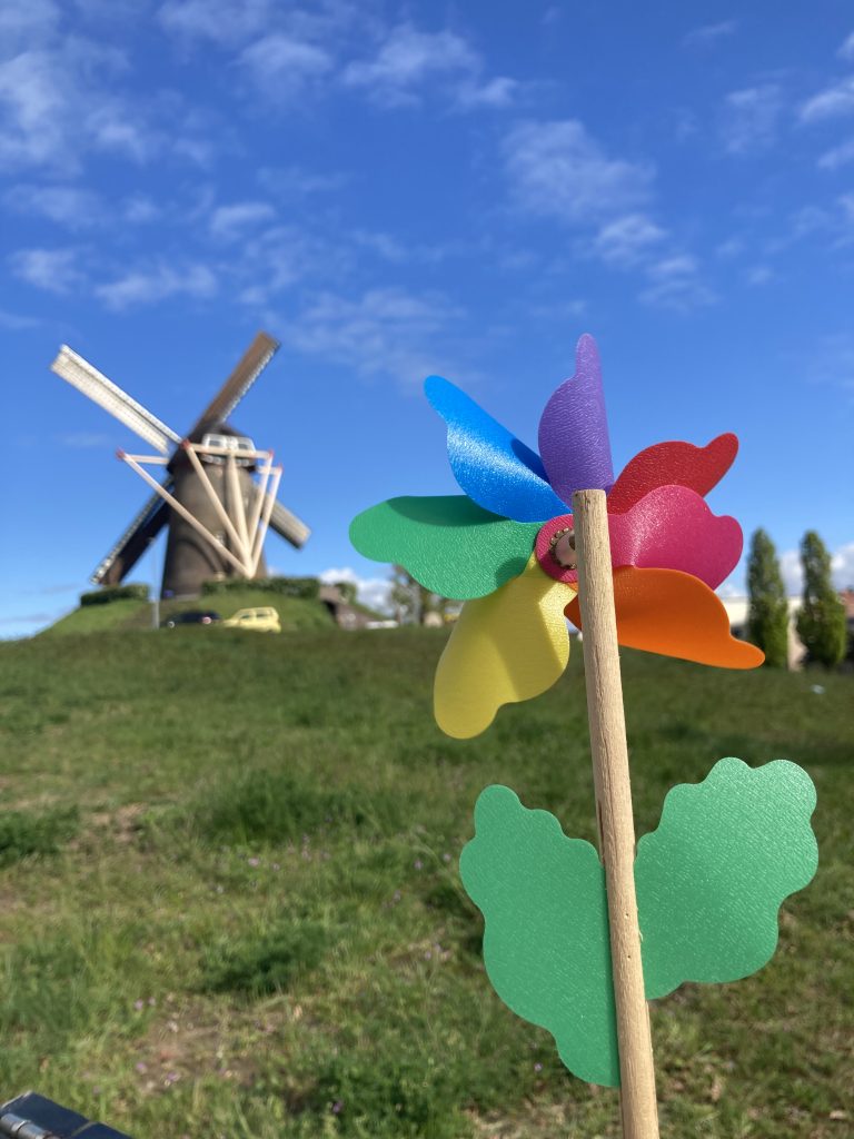 a windmill and a child’s colored pinwheel