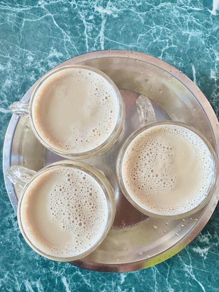 3 cups of coffee on a table photographed from above.