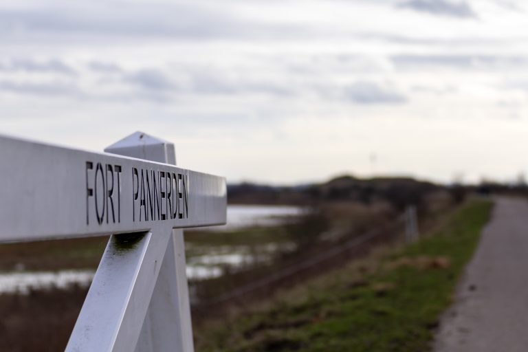 The gate at the road to Fort Pannerden, The Netherlands, with the gate in focus and a blurred background.