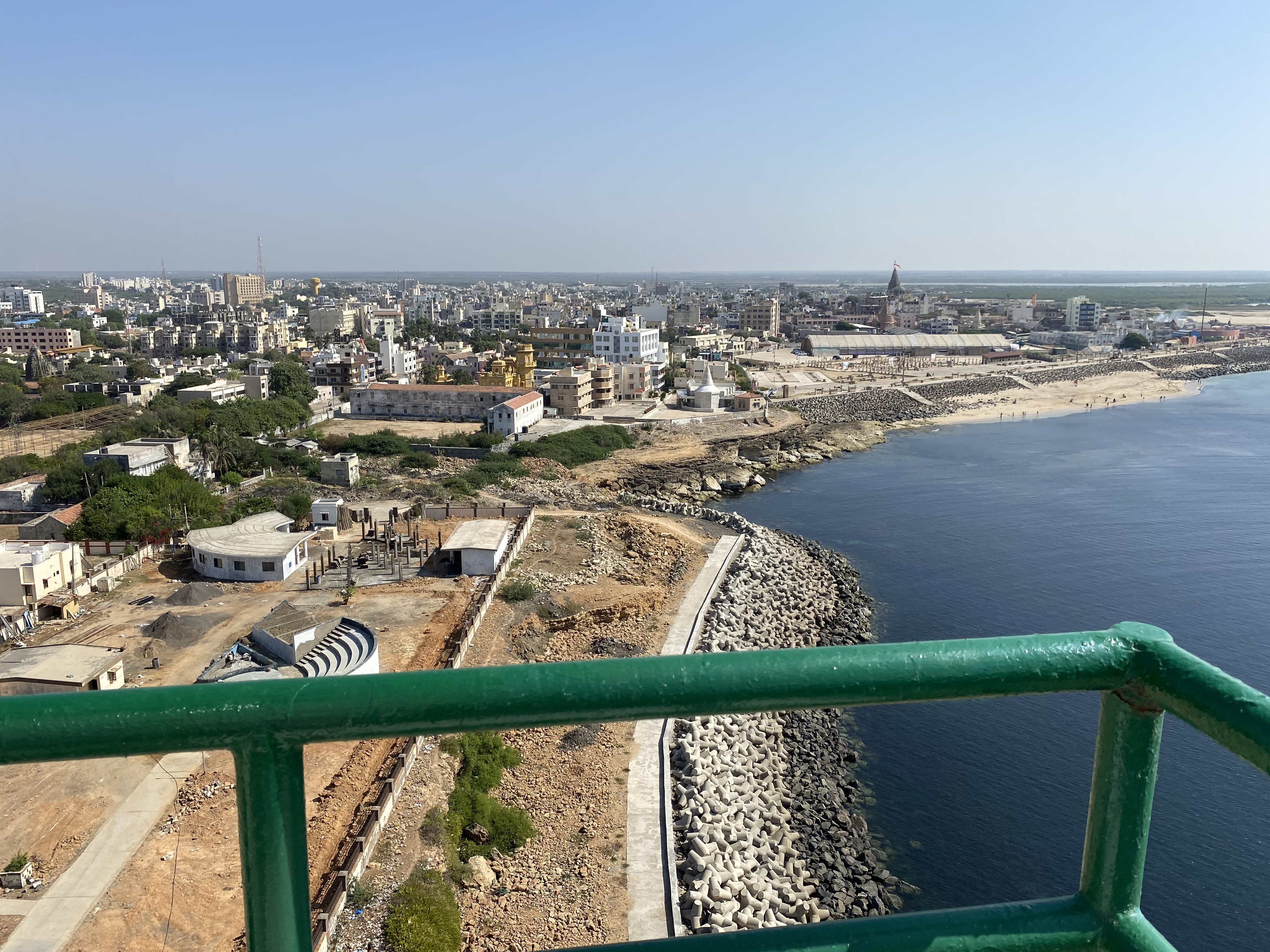 Aerial view of Dwarka, Gujarat, showcasing the cityscape, coastline, and the famous Dwarkadhish Temple in the distance.