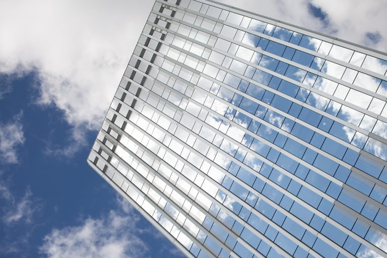 Glass building with the reflections of a blue sky