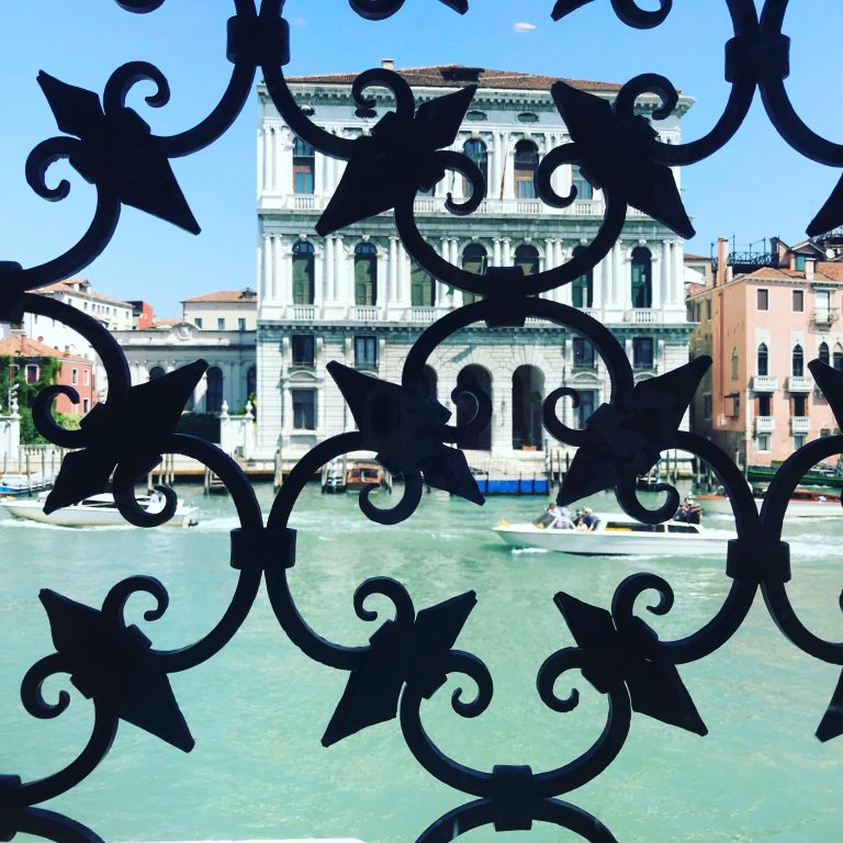 Scenes of Venice – view of canal through the fence