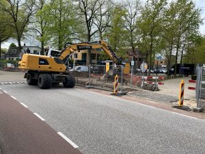 An excavator working while on the street