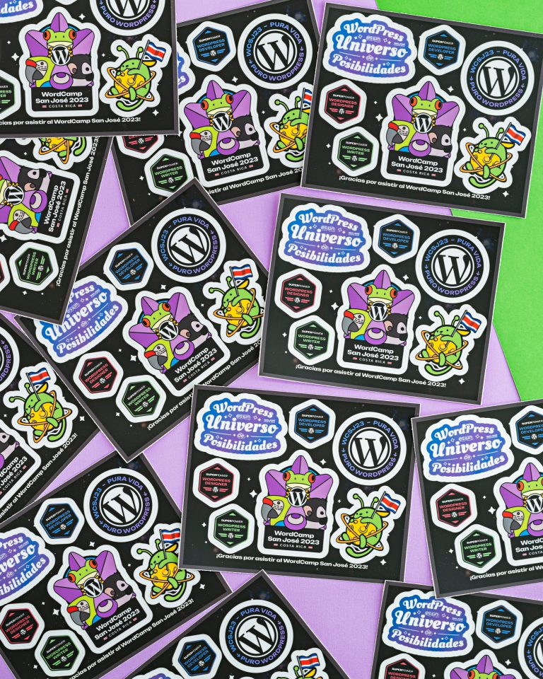 Composition of various Wapuu sticker sheets from WordCamp San José 2023 on a green and violet surface.