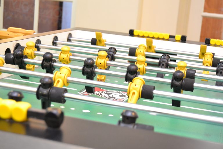 Foosball table with black and wellow pegs